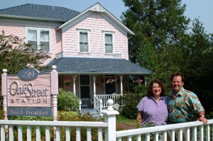 Hosts Sue and John in front of the Oak Street Station B&B